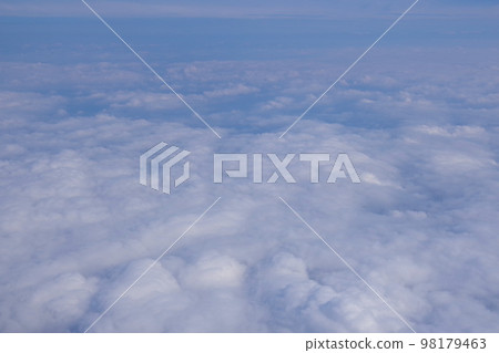 Clouds seen from the plane window Sky above the plane Stratus and cumulus clouds White clouds Clouds seen from the plane window Sky above the plane Stratus and cumulus clouds White clouds 98179463
