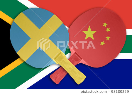 Two tennis rackets on the background of the flags of Sweden and China Two tennis rackets on the background of the flags of Sweden and China 98180259