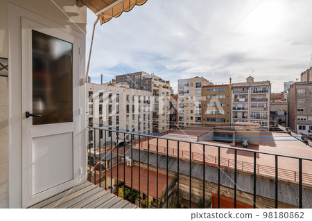 View from a balcony of typical inner courtyard in the Eixample district, Barcelona, Catalonia, Spain on cloudy day. 98180862