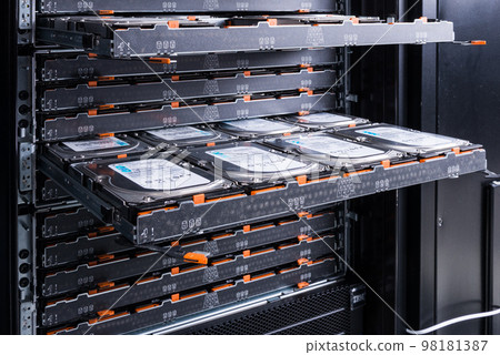 Cluster of hard drives inside open tray - a cloud data storage concept 98181387