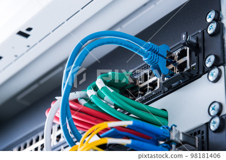 fiber optic cables connected to optic ports, network cables connected to ethernet ports fiber optic cables connected to optic ports, network cables connected to ethernet ports 98181406