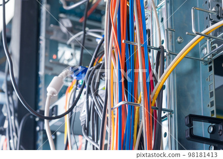 Detail of server room with bunch of fiber optic cables 98181413