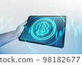 Bitcoin symbol hologram on tablet screen. Cryptocurrency and future technology concept. 98182677