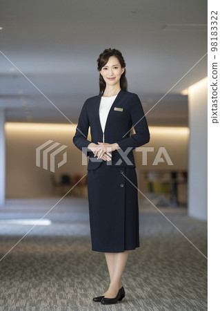 Business woman in her 30s smiling at the camera front staff concierge image 98183322