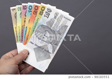 Old Australian money in the hand on a gray background 98183551