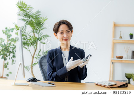 A woman appraising a watch 98183559