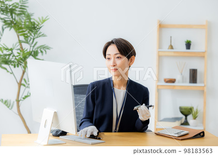 A woman appraising a watch A woman appraising a watch 98183563