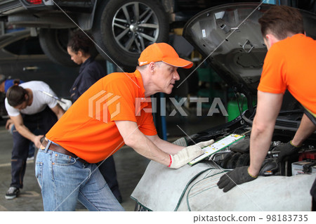 car service, repair, maintenance and people concept - auto mechanic team car service, repair, maintenance and people concept - auto mechanic team 98183735