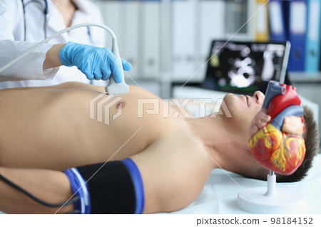 Man on ultrasound of heart in cardiology center 98184152