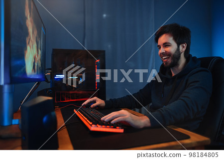 Young guy having fun playing online video games at home 98184805