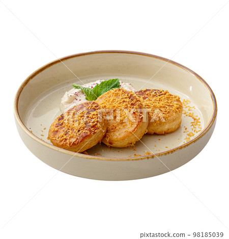 Portion of russian pancakes syrniki with cream Portion of russian pancakes syrniki with cream 98185039