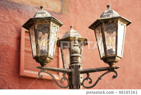 Red brick old wall with a lantern 98185161