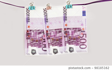 Money background. Euro banknotes hanging a rope with clothes pins. Selective focus 98185162