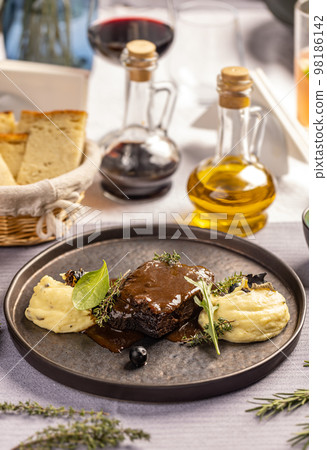 Smoked barbecue beef topped with bbq sauce 98186142