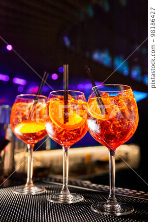 Aperol Spritz cocktail on bar counter in the night club Aperol Spritz cocktail on bar counter in the night club 98186427