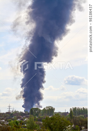 Burning tanks with fuel at the oil depot as a result of a rocket hit Burning tanks with fuel at the oil depot as a result of a rocket hit 98186437
