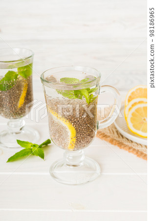 Healthy breakfast or morning with chia seeds lemon and mint on table background, vegetarian food, diet and health concept. Chia pudding with lemon and mint 98186965