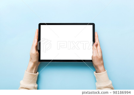 female teen hands using tablet pc with white screen, Mockup image of woman hand holding white tablet pc with blank white screen at home 98186994