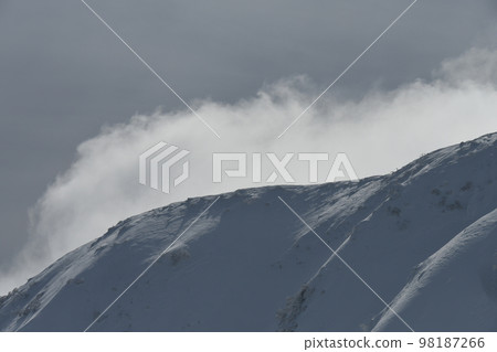 snow fluttering mountainside 98187266