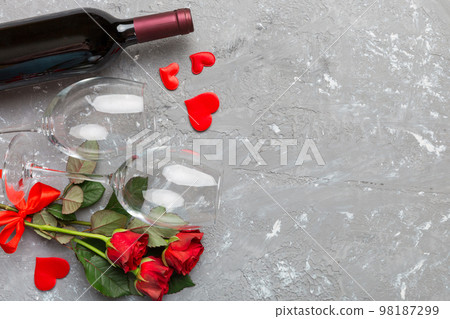 Valentine's day composition with red wine, rose flower and gift box on table. Top view, flat lay. Holiday concept 98187299