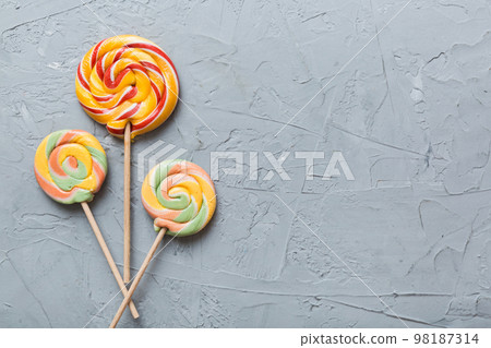 Set of colorful lollipops on colored background. Summer concept. Party Happy Birthday or Minimalist Concept Set of colorful lollipops on colored background. Summer concept. Party Happy Birthday or Minimalist Concept 98187314