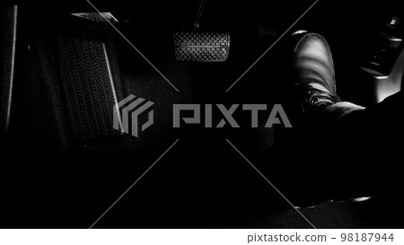 Car accelerate and brake foot pedal. Close up foot press or push foot break and accelerate pedal of a car to drive ahead. Driver driving the car by pressing or pushing accelerator pedals of the car. Car accelerate and brake foot pedal. Close up foot press or push foot break and accelerate pedal of a car to drive ahead. Driver driving the car by pressing or pushing accelerator pedals of the car. 98187944