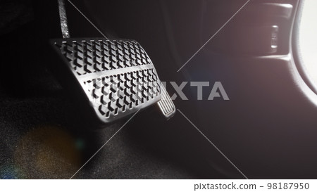 Car accelerate and brake foot pedal. Close up foot press or push foot break and accelerate pedal of a car to drive ahead. Driver driving the car by pressing or pushing accelerator pedals of the car. 98187950