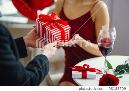 Valentine's Day concept. A loving couple celebrating Valentine's Day in the restaurant. Valentine's Day concept. A loving couple celebrating Valentine's Day in the restaurant. 98188709