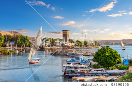 Beautiful view of the sailboats in the Nile and traditional villages of Aswan city, Egypt Beautiful view of the sailboats in the Nile and traditional villages of Aswan city, Egypt 98190106