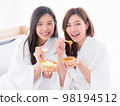 Two young women are relaxing in spa and play with skin care natural products ingredients for scrub body mask 98194512