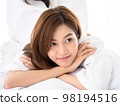 Home spa. Girl felling relaxing and enjoy time on the bed at the home spa. 98194516