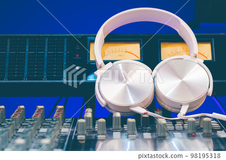 white headphone on audio mixing console. music background white headphone on audio mixing console. music background 98195318