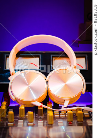 white headphone on audio mixing console. music background white headphone on audio mixing console. music background 98195319