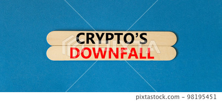 Crypto downfall symbol. Concept words Cryptos downfall on wooden stick. Beautiful blue table blue background. Business and crypto downfall concept. Copy space. 98195451
