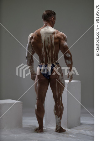 Sexy male back view of shirtless athletic strong man at studio Sexy male back view of shirtless athletic strong man at studio 98195670