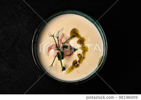 Bowl of Cheese soup with shrimps on black background Bowl of Cheese soup with shrimps on black background 98196009