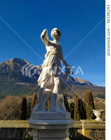 Classic white marble statuette Diana statue isolated on blue sky background. Scilpture of huntress Classic white marble statuette Diana statue isolated on blue sky background. Scilpture of huntress 98196243