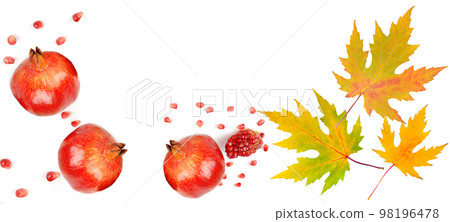 Pomegranate fruit and autumn maple leaves isolated on white. Free space for text. Wide photo. Collage. Pomegranate fruit and autumn maple leaves isolated on white. Free space for text. Wide photo. Collage. 98196478