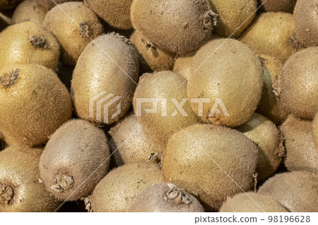 kiwi in the peel close-up. ripe kiwi fruit on store shelf background kiwi in the peel close-up. ripe kiwi fruit on store shelf background 98196628