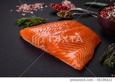 Fillet of raw red salmon fish with salt, spices and herbs 98196822