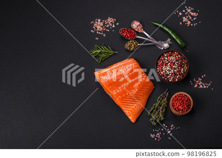 Fillet of raw red salmon fish with salt, spices and herbs 98196825