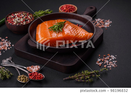 Fillet of raw red salmon fish with salt, spices and herbs Fillet of raw red salmon fish with salt, spices and herbs 98196832