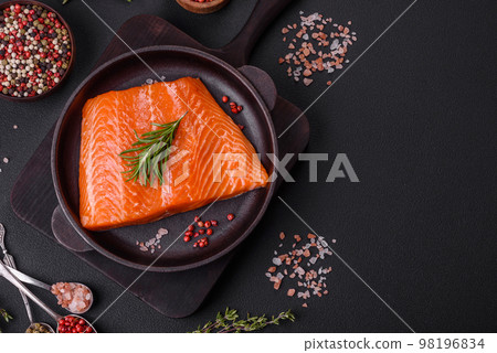 Fillet of raw red salmon fish with salt, spices and herbs Fillet of raw red salmon fish with salt, spices and herbs 98196834