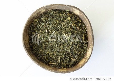 Dried Nettles in a Wooden Bowl on a Beige Background View from Above. Healthful Natural Tea. 98197226