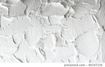 Macro photo of a white rough wall. Close-up of the putty Macro photo of a white rough wall. Close-up of the putty 98197236