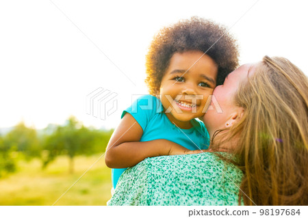 little girl with cool afro curly hair having fun together with mom outdor little girl with cool afro curly hair having fun together with mom outdor 98197684