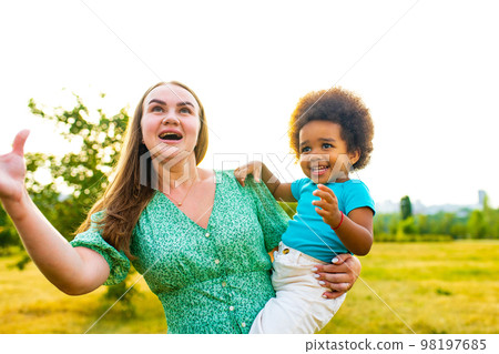 little girl with cool afro curly hair having fun together with mom outdor 98197685