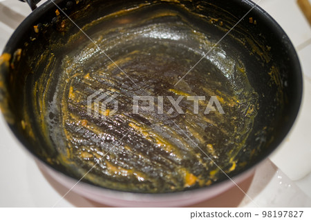 Frying pan covered with curry 98197827