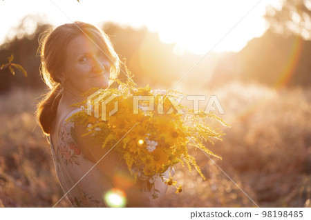 girl in the field at sunset girl in the field at sunset 98198485