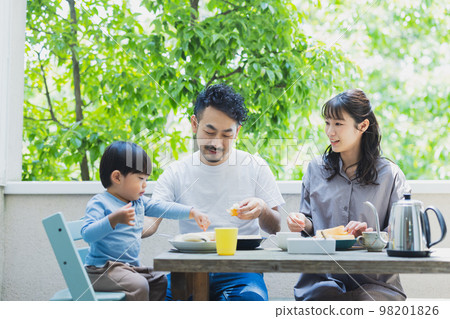 Family eating breakfast on the terrace 98201826